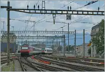 A SBB Re 460 wiht his IR 90 to Brig is leaving Lausaanne and a SBB RABe 523 is comming in. 

19.07.2024