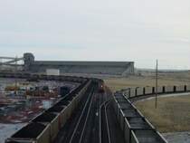 Two trains are being loaded, one BNSF, one UP, while another UP heads off on the staging track to the right. Thunder Basin Coal Co. near Wright, Wyoming 10 Nov 2003.