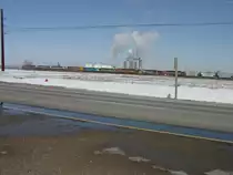 The 9 loks are rolling fast now, as they pass the new ethanol plant west of Burlington, Iowa. 3 Mar 2010
