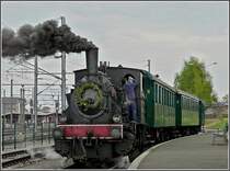 The steam engine AL-T3 6114 with heritage wagons is waiting for passengers at P�tange on May 1st, 2010.