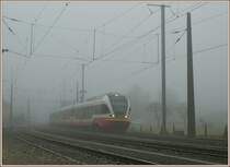 By a heavy fog is entering in the Noiraigue station the TRN local train to Buttes. 
07.12.2009