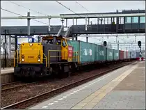 The Railion diesel engine 6440 is heading a freight train in Lage Zwaluwe on March 10th, 2011.