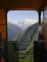 2 ft gauge steam engine  Liseli  (Jung No 1693, built 1911) in service on the high alpin panoramic railway of  Parc d'Attractions du Chatelard (VS)  in Switzerland.
In the station  Pied du Barrage  on 1'800 metres about sea level. View through the loco cabin, photo taken from the platform. To see is the highest mountain of the Alps, called  Mont Blanc . In the valley, 700 metres deeper than the railway line situatet, the village  Vallorcine  is to see (just on the other site of the national boarder to France). 02 July 2011
