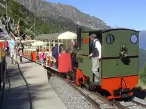 2 ft gauge steam engine  Liseli  (Jung No 1693, built 1911) in service on the high alpin panoramic railway of  Parc d'Attractions du Chatelard (VS)  in Switzerland. Passengers boarding the train just after arriving in the station  Les Montuires , where the most steep funiculair in the world (2 cabines, gradient max. 84%) reaches their upper station. 11 Sept 2010